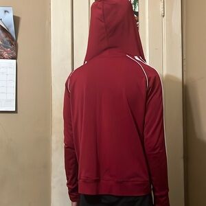 Women’s zip up jacket in a burgundy color with white strips